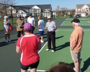 Paddleball players chatting.  Photo Credit goes to the Coastal Point.